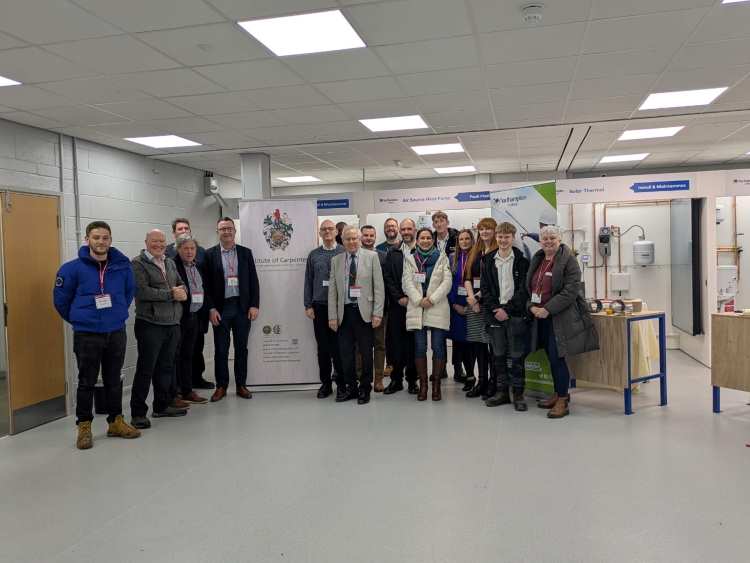 Attendees pose in the College's Green Skills Centre.